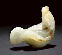 Ming dynasty A pale celadon and russet jade model of a hen